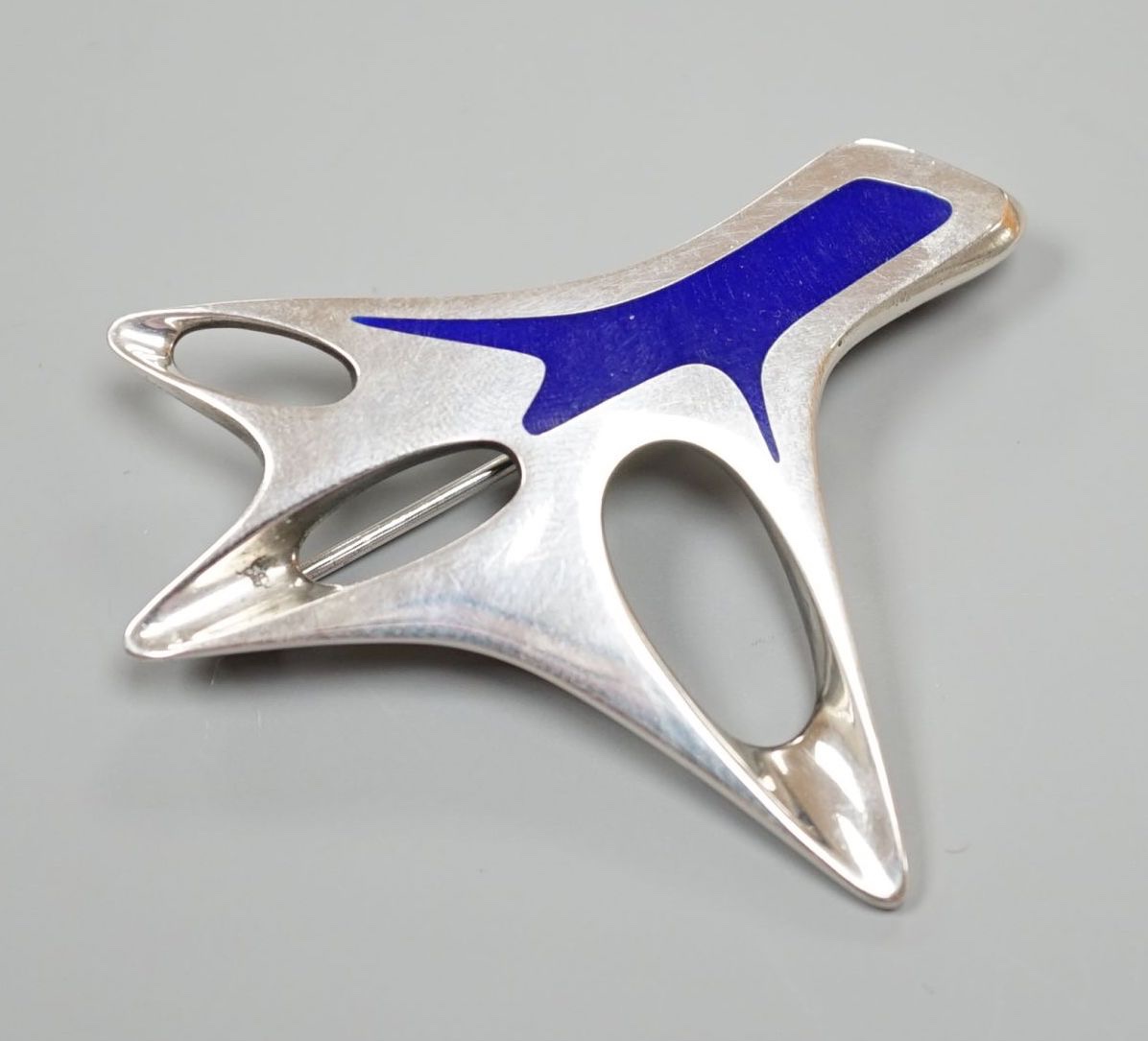 A Henning Koppel for Georg Jensen sterling and blue enamel abstract brooch, no. 323, 60mm (pin a.f.).